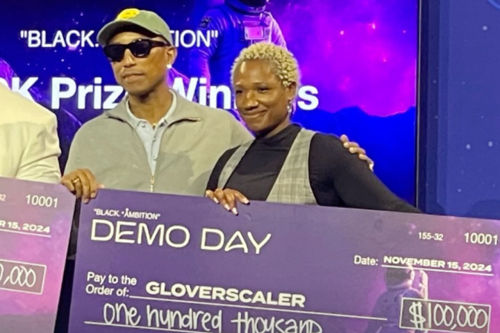 Pharrell Williams awarding Crystal Lugo of Glove Scaler a $100,000 prize at the 2024 Black Ambition Demo Day.